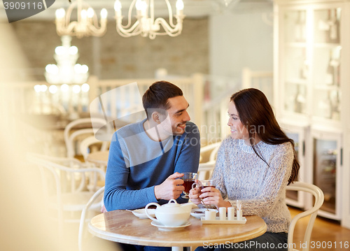 Image of happy couple drinking tea at cafe