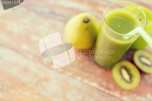 Image of close up of fresh green juice and fruits on table