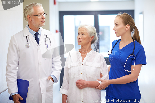 Image of medics and senior patient woman at hospital