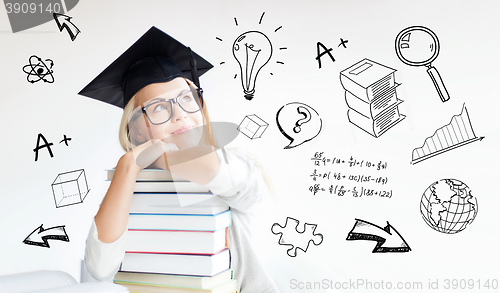 Image of happy student woman in mortarboard with books