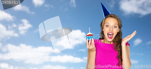 Image of happy woman or teen girl with birthday cupcake
