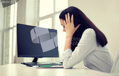 Image of close up of sad woman with computer and notebook