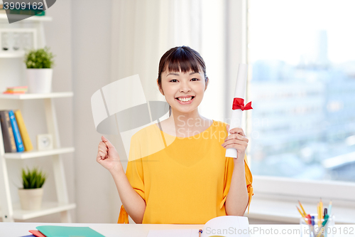 Image of happy asian woman student with diploma at home