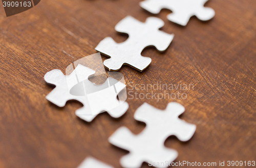 Image of close up of puzzle pieces on wooden surface