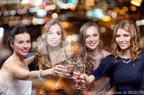 Image of happy women with champagne glasses at night club