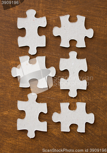 Image of close up of puzzle pieces on wooden surface