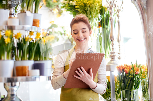 Image of florist woman with clipboard at flower shop