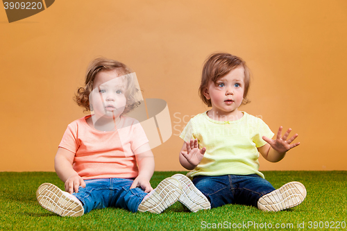 Image of Happy funny girl twins sisters playing and laughing