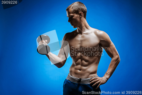 Image of Fit young man with beautiful torso on blue background