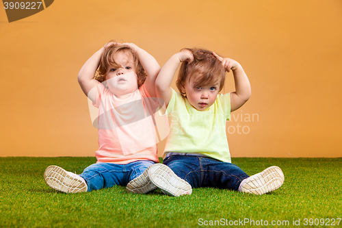 Image of Happy funny girl twins sisters playing and laughing