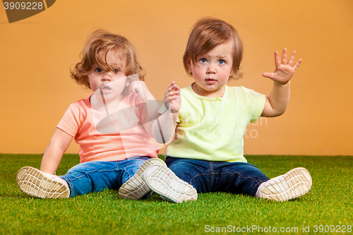 Image of Happy funny girl twins sisters playing and laughing