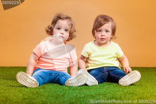 Image of Happy funny girl twins sisters playing and laughing