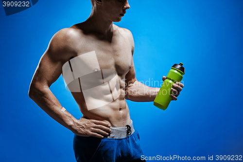 Image of Fit young man with beautiful torso on blue background