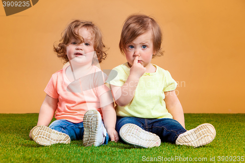 Image of Happy funny girl twins sisters playing and laughing