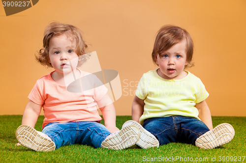 Image of Happy funny girl twins sisters playing and laughing