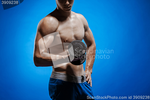 Image of Fit young man with beautiful torso on blue background