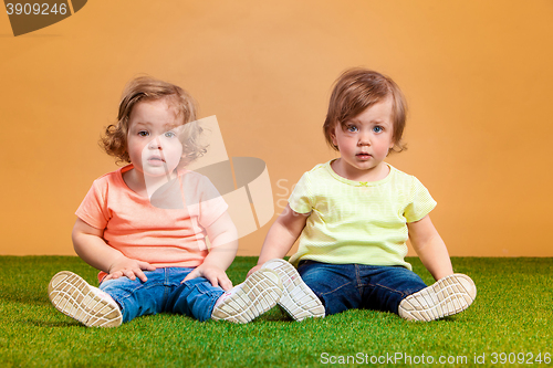 Image of Happy funny girl twins sisters playing and laughing