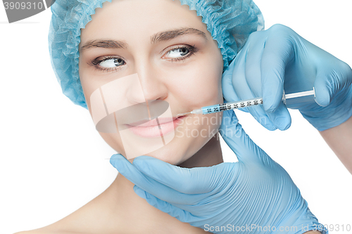 Image of Attractive woman at plastic surgery with syringe in her face