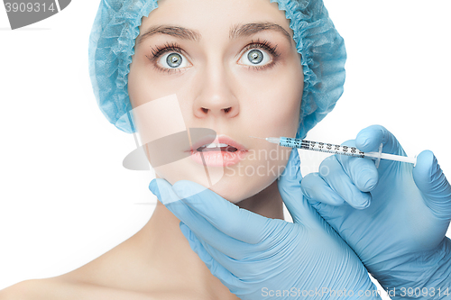 Image of Attractive woman at plastic surgery with syringe in her face