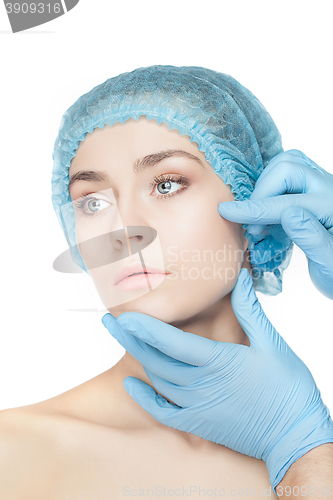 Image of Plastic surgery concept. Doctor hands in gloves touching woman face