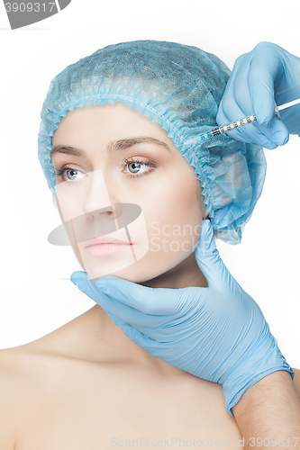 Image of Attractive woman at plastic surgery with syringe in her face