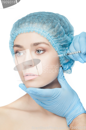 Image of Attractive woman at plastic surgery with syringe in her face