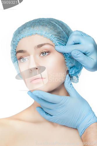 Image of Plastic surgery concept. Doctor hands in gloves touching woman face