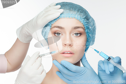 Image of Attractive woman at plastic surgery with syringe in her face