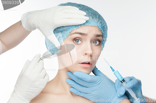 Image of Attractive woman at plastic surgery with syringe in her face