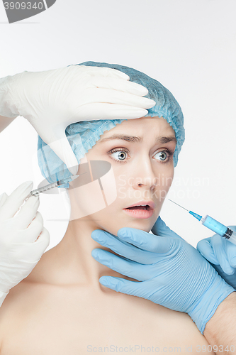Image of Attractive woman at plastic surgery with syringe in her face