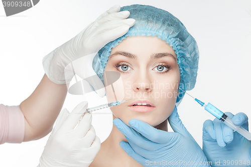 Image of Attractive woman at plastic surgery with syringe in her face