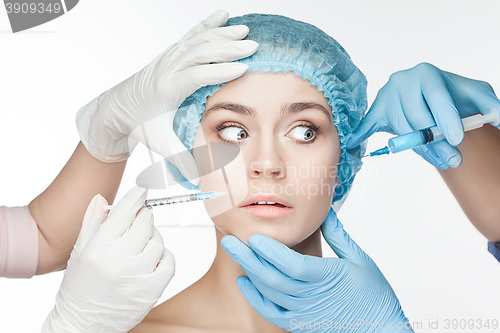 Image of Attractive woman at plastic surgery with syringe in her face