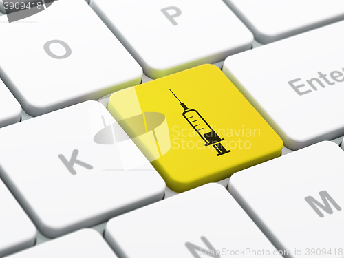 Image of Healthcare concept: Syringe on computer keyboard background