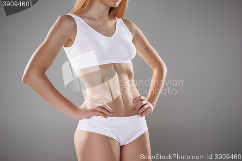 Image of Young, slim, healthy and beautiful woman in white lingerie