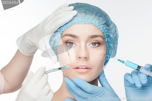 Image of Attractive woman at plastic surgery with syringe in her face