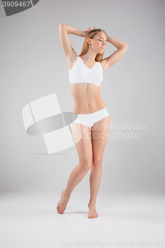 Image of Young, slim, healthy and beautiful woman in white lingerie