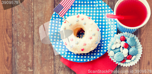 Image of donut with juice and candies on independence day