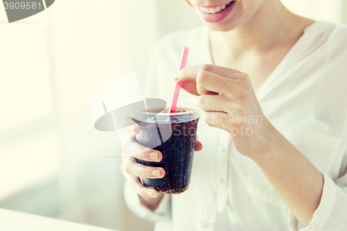 Image of close up of happy woman drinking coca cola