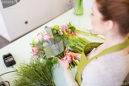 Image of close up of woman making bunch at flower shop