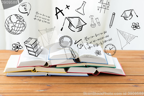 Image of close up of books on table over school doodles