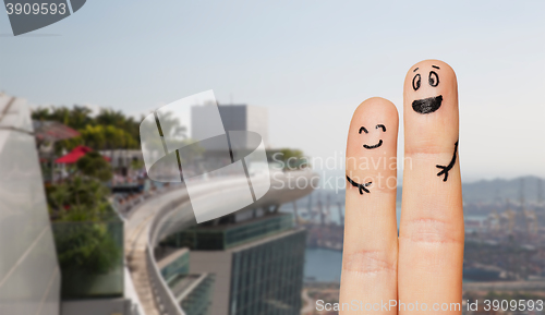 Image of close up of two fingers with smiley faces