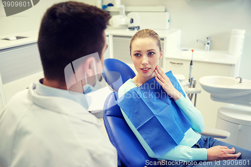 Image of male dentist with woman patient at clinic