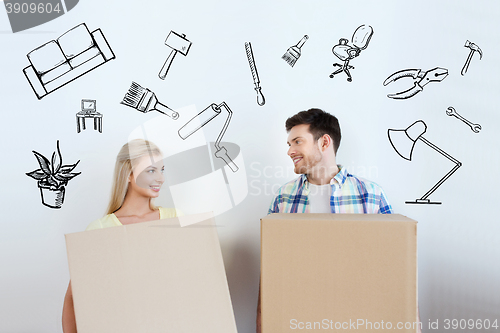 Image of smiling couple with big boxes moving to new home