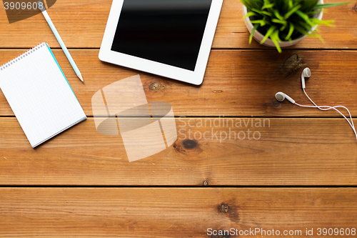 Image of close up of tablet pc computer on wooden table