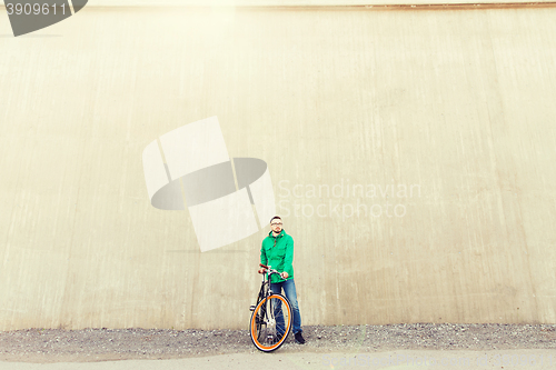 Image of happy young hipster man with fixed gear bike