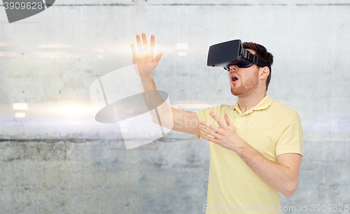 Image of happy man in virtual reality headset or 3d glasses