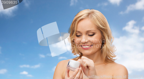 Image of happy woman with cream jar