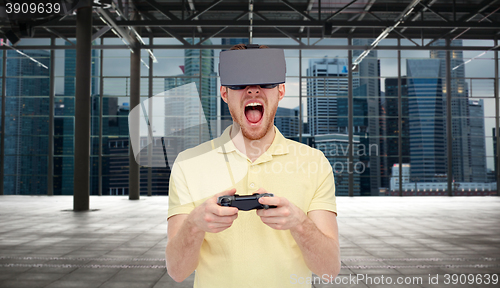 Image of angry man in virtual reality headset with gamepad