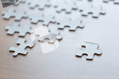 Image of close up of puzzle pieces on wooden surface