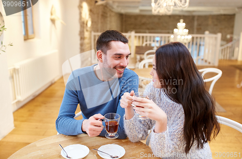 Image of happy couple drinking tea at cafe